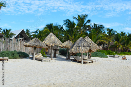 resting place on a tropical beach. sun loungers in an exotic resort. picturesque landscape of the southern country. palms and beds