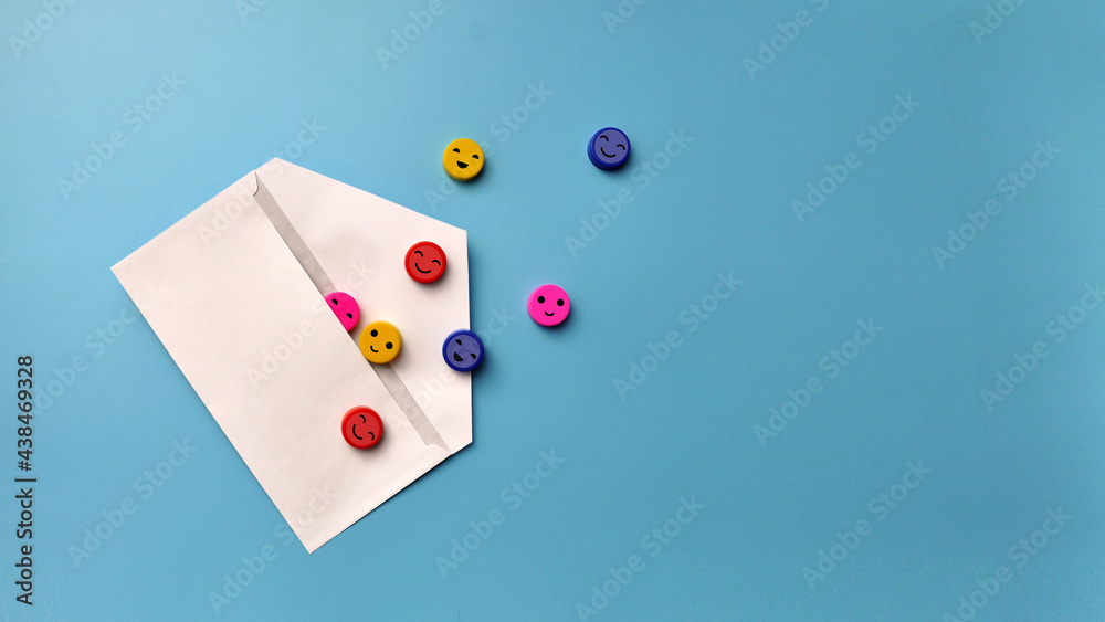 A letter with smiling faces inside. A symbol of a pleasant, joyful message A letter with smiling faces inside. A symbol of a pleasant, joyful message