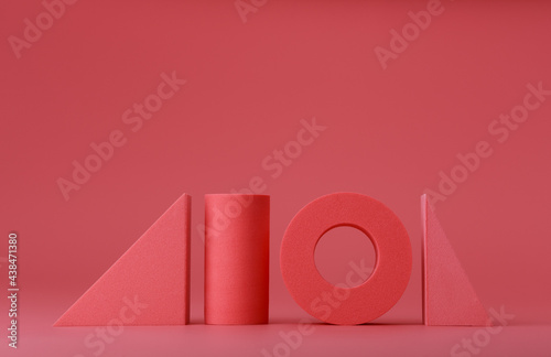 Pink abstract background with pink geometric figures in a row. Copy space. Concept of pink abstract template