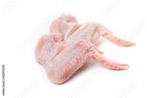 Raw chicken wings with skin on a white background.