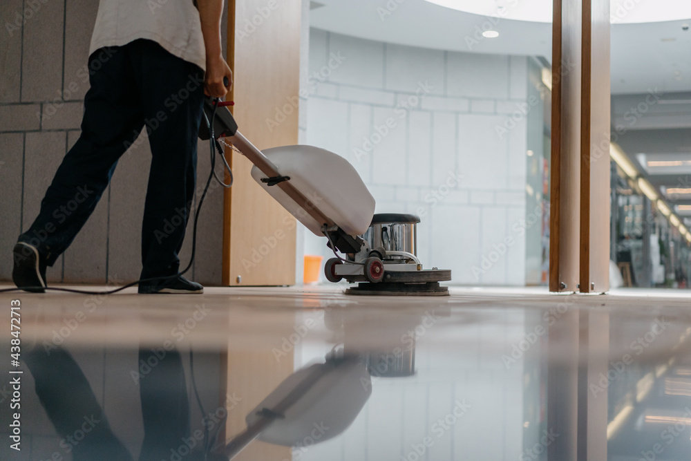 Fototapeta premium cleaning floor with machine