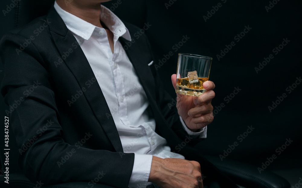 Man wearing a suit whiskey glass of liquor Man wearing a suit whiskey glass of liquor