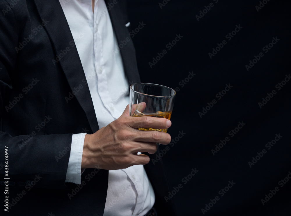 Man wearing a suit whiskey glass of liquor Man wearing a suit whiskey glass of liquor