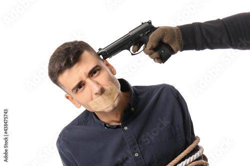 Terrorist aiming at hostage on white background