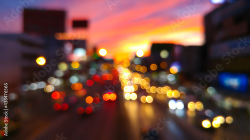 Bokeh from car lights on a street at dusk. © kamoljindamanee