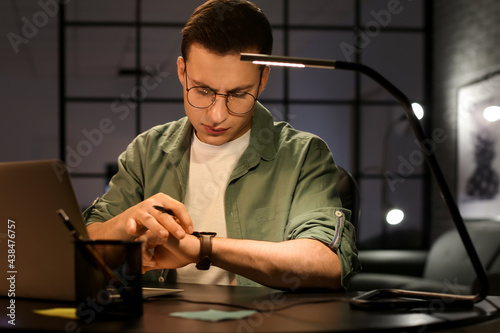 Handsome man looking at wri...