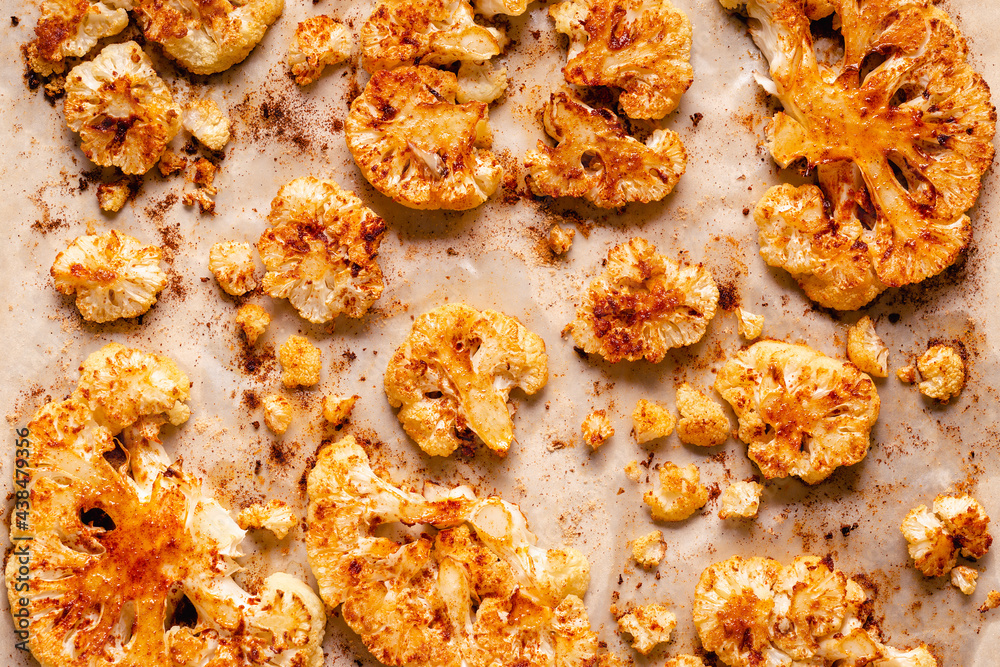 Cauliflower steak with spices cooked in the oven, top view. Cauliflower steak with spices cooked in the oven, top view.