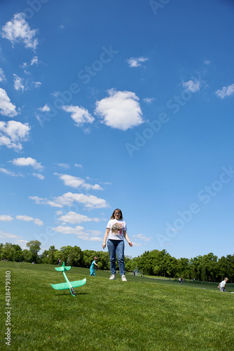 Adult woman 40 years old launches a glider plane into the sky