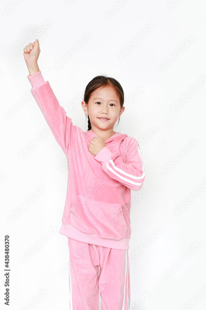 Adorable little Asian child girl in pink tracksuit or sport cloth with fight expression isolated on white background. Portrait half-length of kid girl. Confident concept. Adorable little Asian child girl in pink tracksuit or sport cloth with fight expression isolated on white background. Portrait half-length of kid girl. Confident concept.