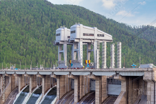 View on giant gantry cranes to hydroelectric power station of Krasnoyarsk dam located on the Yenisey River near Krasnoyarsk in Divnogorsk, Russia. This crane adjusts the valves during floods. photo