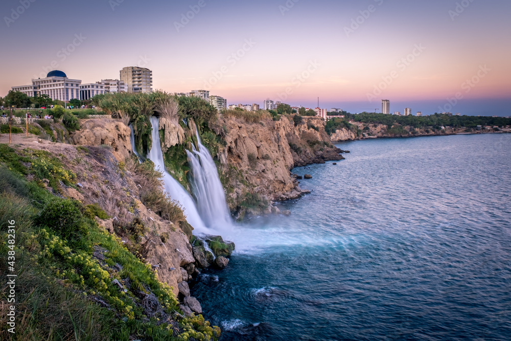 Waterfall Duden falling into the Mediterranean sea in Antalya, Turkey. Sunset in Antalya