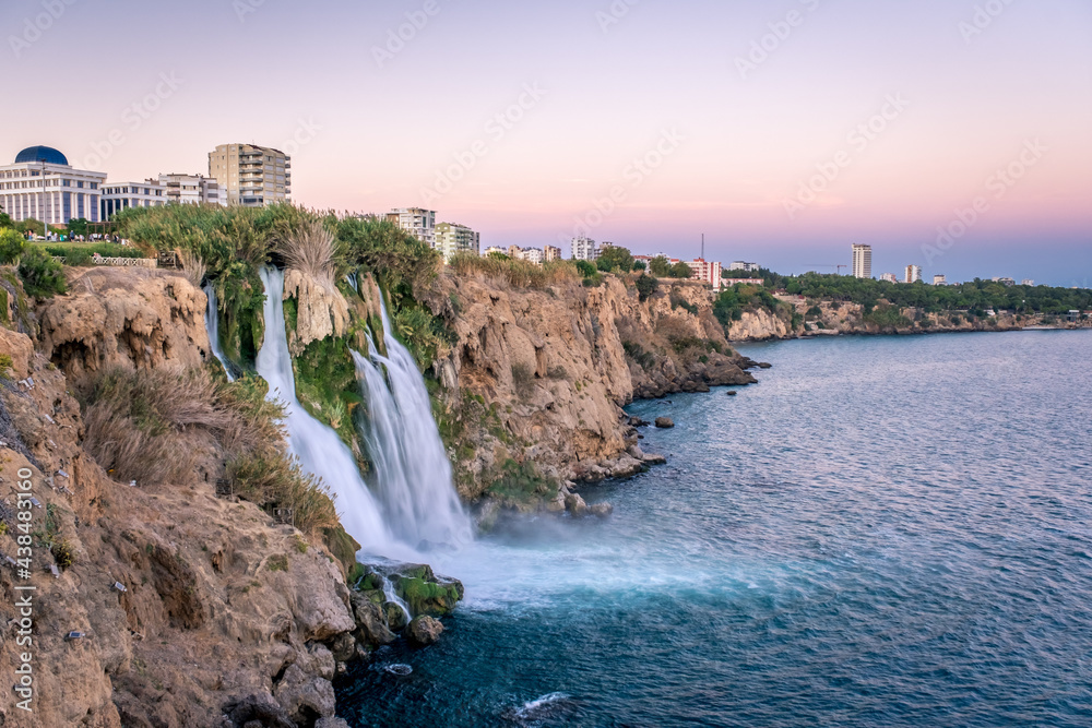Waterfall Duden falling into the Mediterranean sea in Antalya, Turkey. Sunset in Antalya