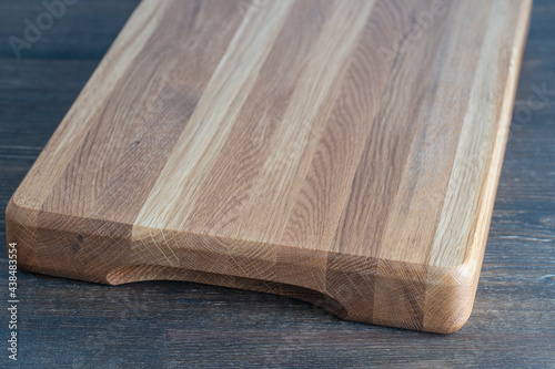 Wooden cutting board on wooden table background