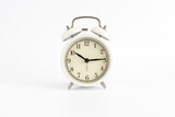 White retro clock alarm clock on white background shows 10:15 am or 10:15 pm or 22:15