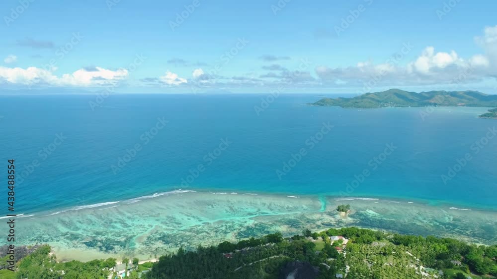 The most photographed beach in the world is Anse Source d'Argent in the Seychelles, on the island of La Digue. The drone flies over the surface of the water past rocks and palm trees The most photographed beach in the world is Anse Source d'Argent in the Seychelles, on the island of La Digue. The drone flies over the surface of the water past rocks and palm trees