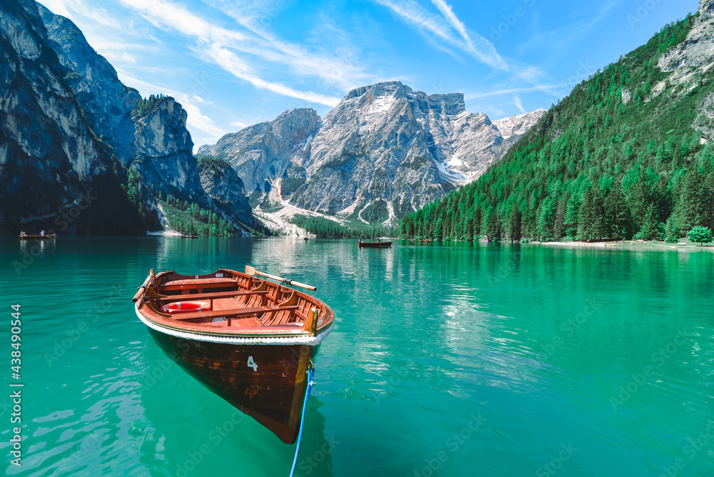brown wooden boat in clear blue water of mountain lake