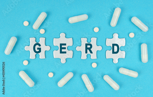 On a blue background, there are pills and puzzles with the inscription - GERD