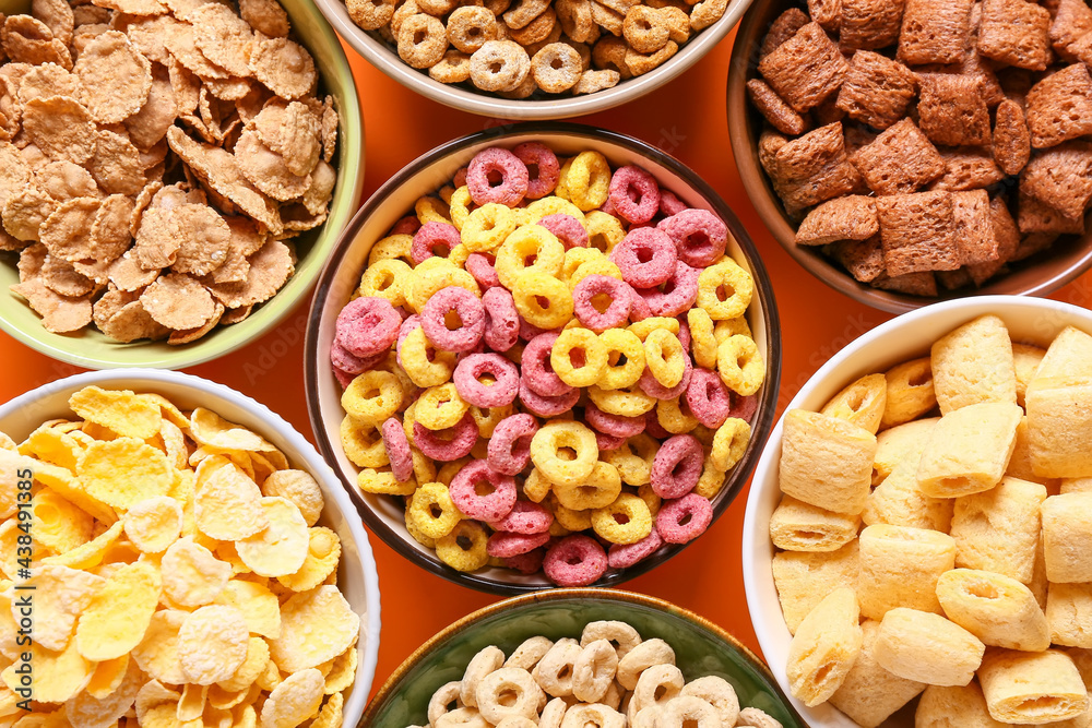 Bowls with different cereals on color background, closeup Bowls with different cereals on color background, closeup