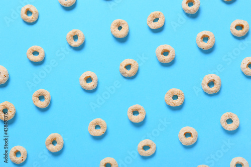 Tasty cereal rings on color background  closeup