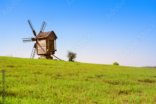 Summer landscape with old countryside windmill