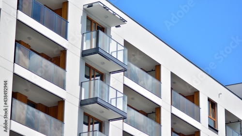 Fragment of modern luxury residential apartment, home house building concept. Modern apartment building on a sunny day with a blue sky.