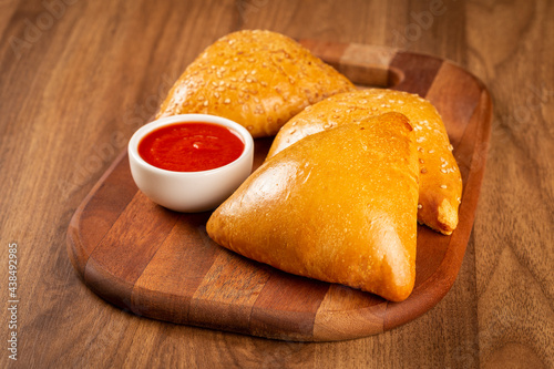 Arabic meat sfiha with juice cop on the table.