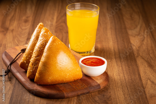 Arabic meat sfiha with juice cop on the table.