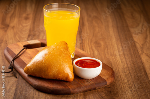 Arabic meat sfiha with juice cop on the table.