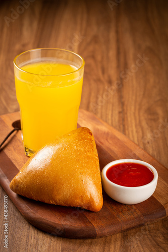 Arabic meat sfiha with juice cop on the table.