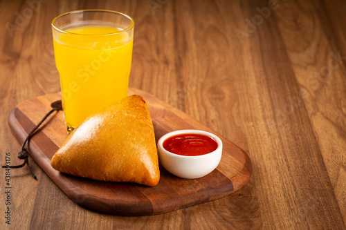 Arabic meat sfiha with juice cop on the table.