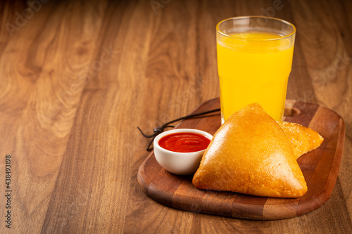 Arabic meat sfiha with juice cop on the table.