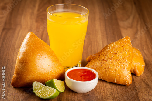 Arabic meat sfiha with juice cop on the table.