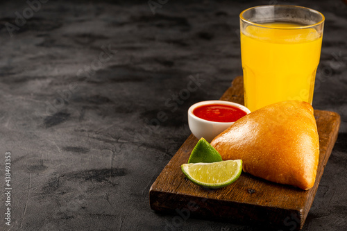 Arabic meat sfiha with juice cop on the table.