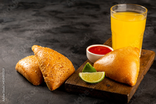 Arabic meat sfiha with juice cop on the table.