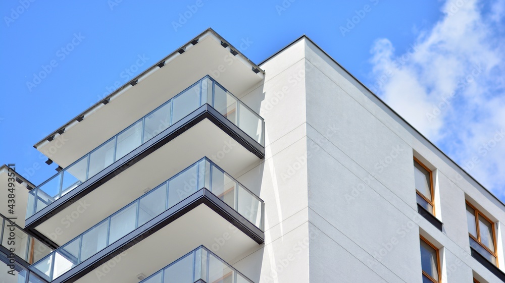 Fragment of modern luxury residential apartment, home house building concept. Modern apartment building on a sunny day with a blue sky. Fragment of modern luxury residential apartment, home house building concept. Modern apartment building on a sunny day with a blue sky.