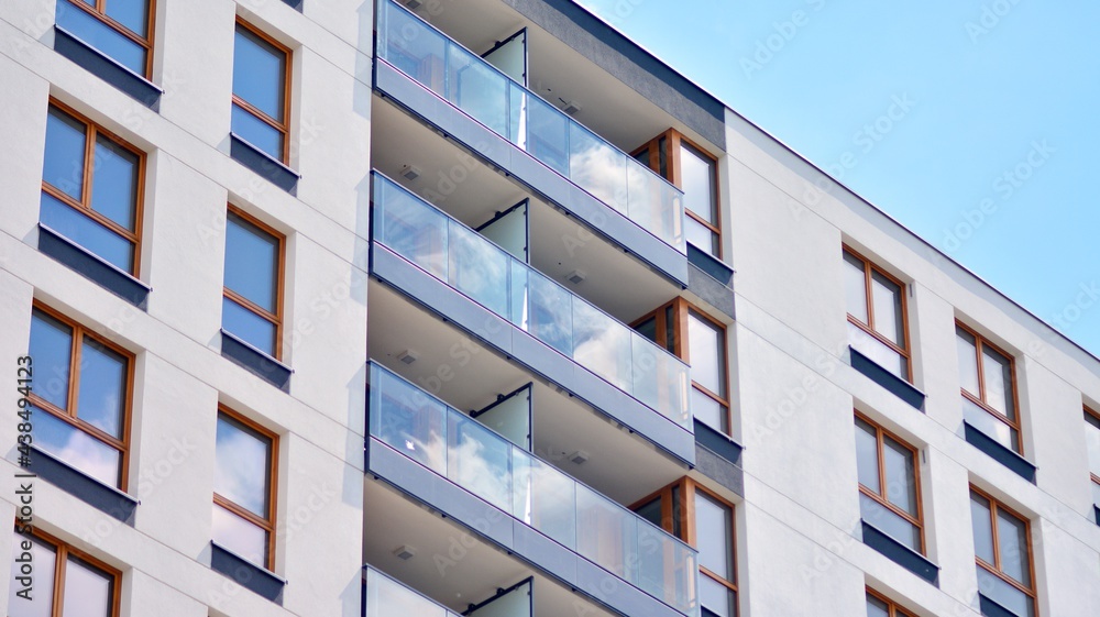 Fragment of modern luxury residential apartment,  home house building concept. Modern apartment building on a sunny day with a blue sky.