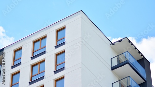 Fragment of modern luxury residential apartment, home house building concept. Modern apartment building on a sunny day with a blue sky.