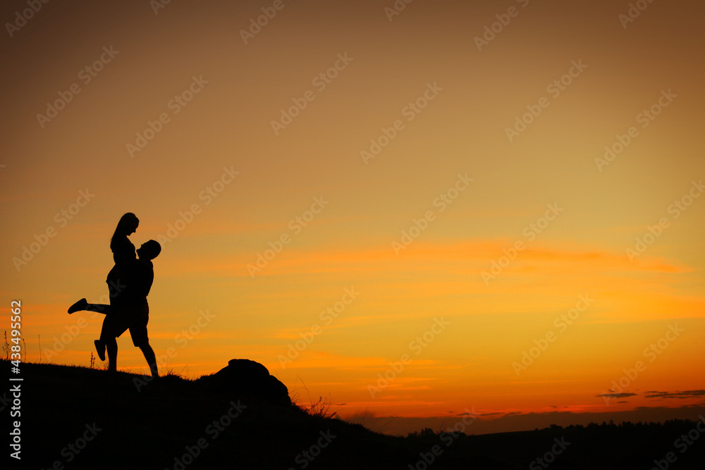 silhouette of a person on a rock