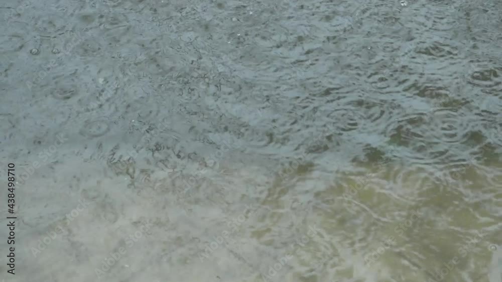 Monsoon rain falling on clean water surface. Torrential Rain raindrops of water in Summer. Beautiful rainy season. Abstract Pattern texture. Nature background. Stock Footage. Copy Space Room for text. Monsoon rain falling on clean water surface. Torrential Rain raindrops of water in Summer. Beautiful rainy season. Abstract Pattern texture. Nature background. Stock Footage. Copy Space Room for text.