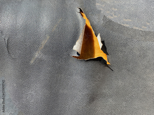 old torn dermantine car seat closeup background