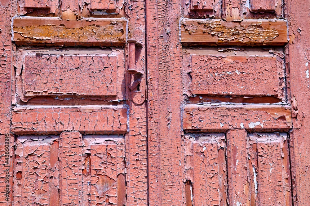 Texture of the old door. Peeling paint on wooden doors as a deta Texture of the old door. Peeling paint on wooden doors as a deta