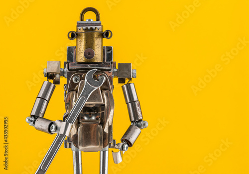 Steampunk robot holding wrench. Chrome and bronze parts.