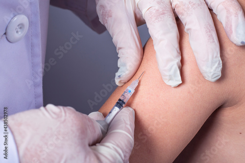 close up doctor holding syringe and using cotton before make injection to patient