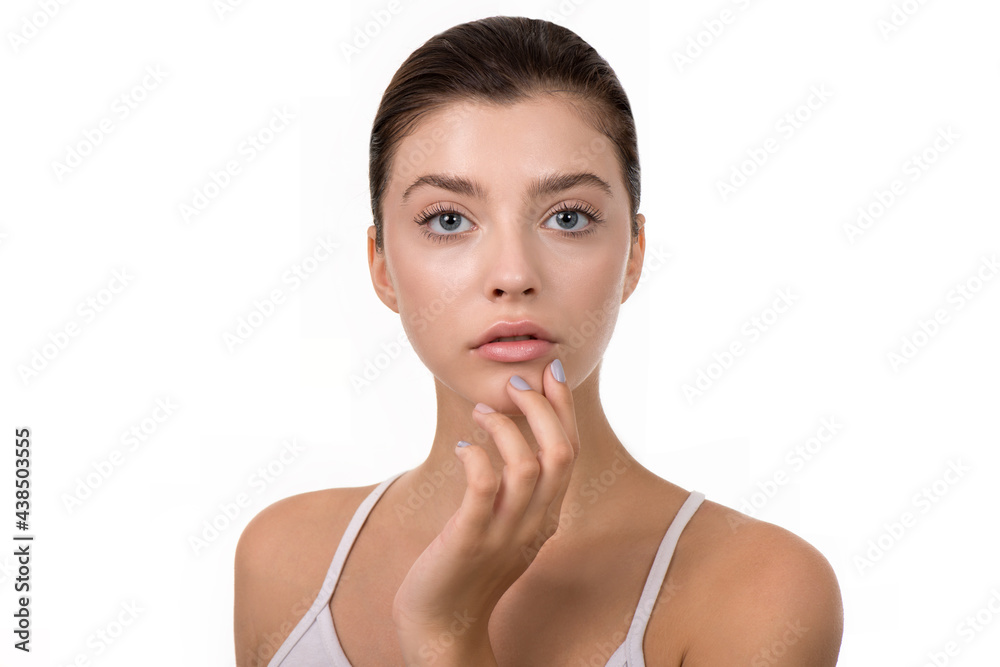 Young woman with clean perfect skin. Portrait of beauty model with natural make up and and hand with manicure touching face. Spa, skincare and wellness. Isolated on white background with copyspace Young woman with clean perfect skin. Portrait of beauty model with natural make up and and hand with manicure touching face. Spa, skincare and wellness. Isolated on white background with copyspace