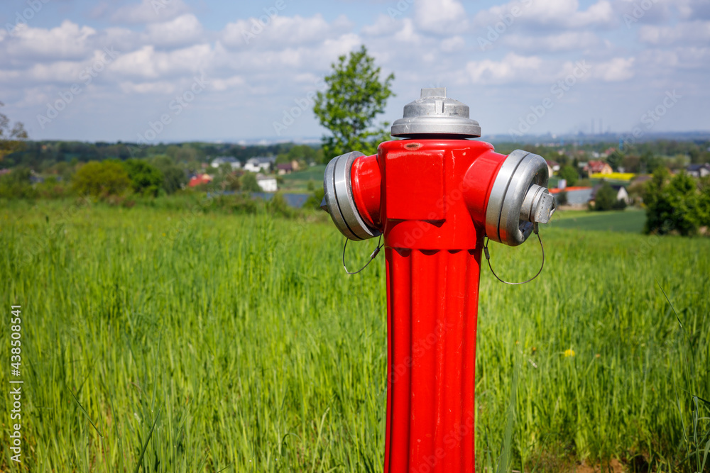 hydrant to connect water on the field, city far in the background. The concept of connections needed in agriculture or in the construction of houses outside the city hydrant to connect water on the field, city far in the background. The concept of connections needed in agriculture or in the construction of houses outside the city