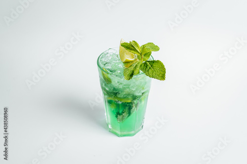 Fresh mojito cocktail in glasses on bright background with lime ant mint lefs, alcoholic cocktail. photo