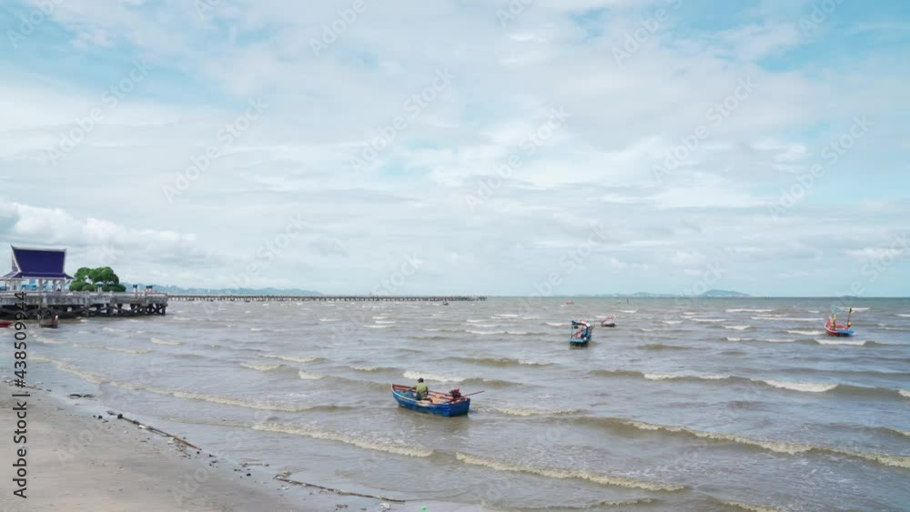 Pan shot landscapes view of beach sea and sky in partially cloudy day. Sea space area with wood fishing boat in Thailand. Pan shot landscapes view of beach sea and sky in partially cloudy day. Sea space area with wood fishing boat in Thailand.