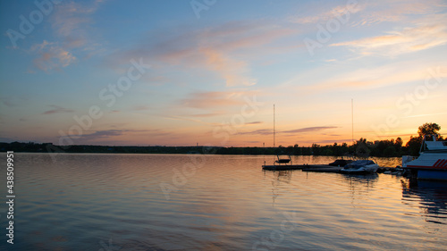 boats on the lake on the background of the sunset © евгений ставников