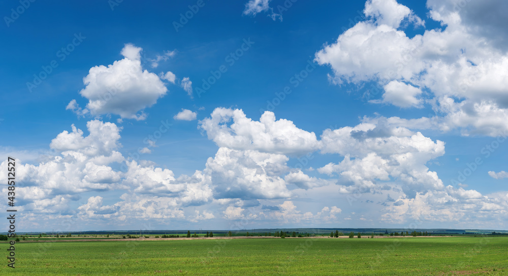 White clouds on a blue sky in sunny weather, background.