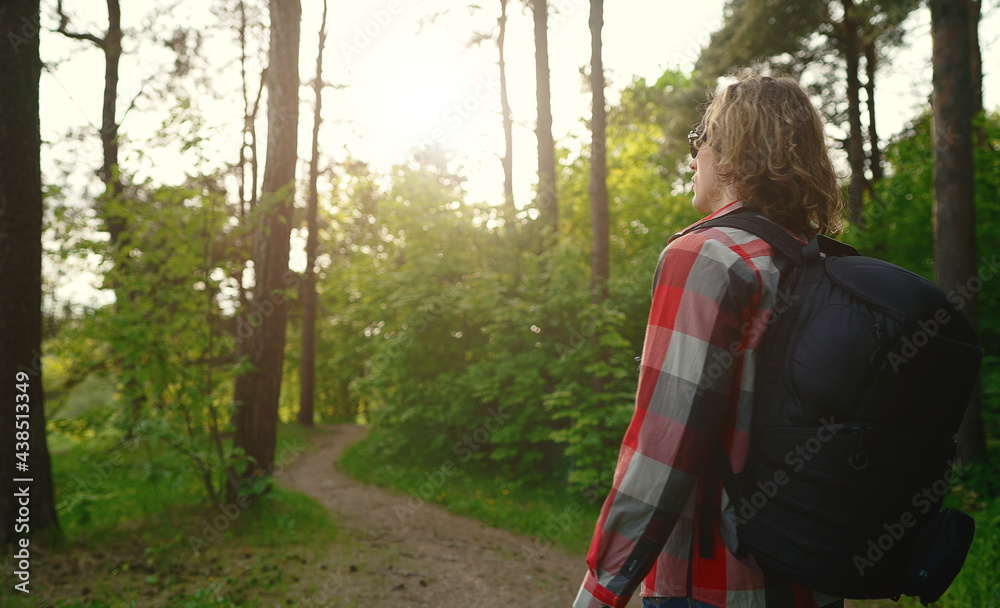 Man with backpack and sunglasses in the woods. Arc shoot. Man with backpack and sunglasses in the woods. Arc shoot.